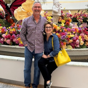 two people at a market smiling for the camera