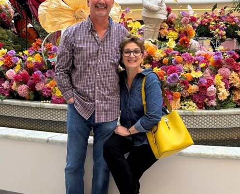 two people at a market smiling for the camera