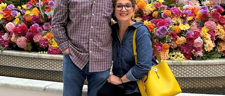 two people at a market smiling for the camera